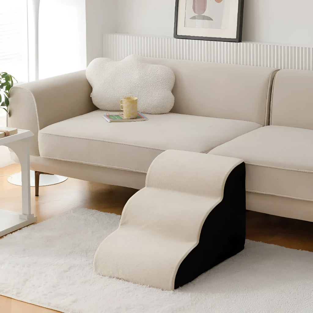 Brown wooden dog stairs with washable fabric cover next to a sofa