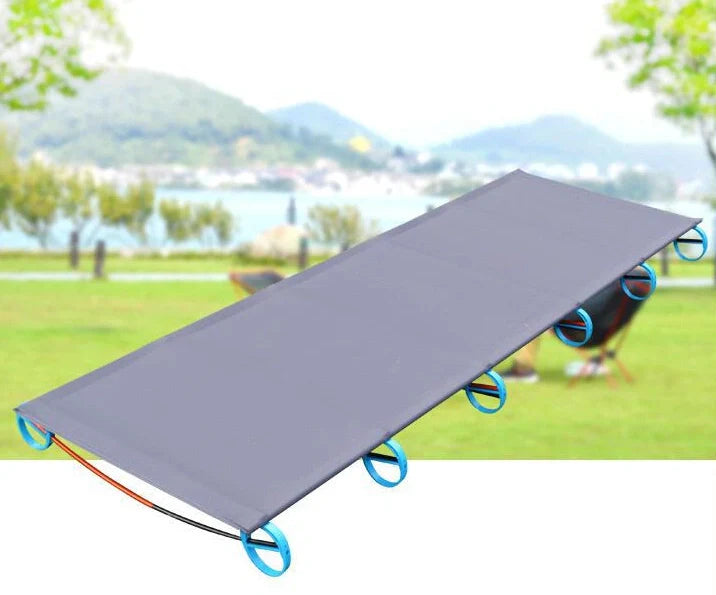 Grey aluminium camp bed folded to 41cm length with carrying bag