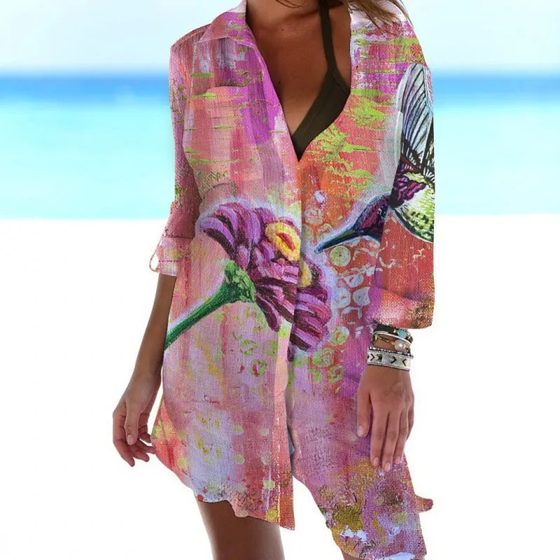 Close-up of a women's slim-fit blouse with a detailed 3D bird and flower digital print on a cardigan-style sleeve.