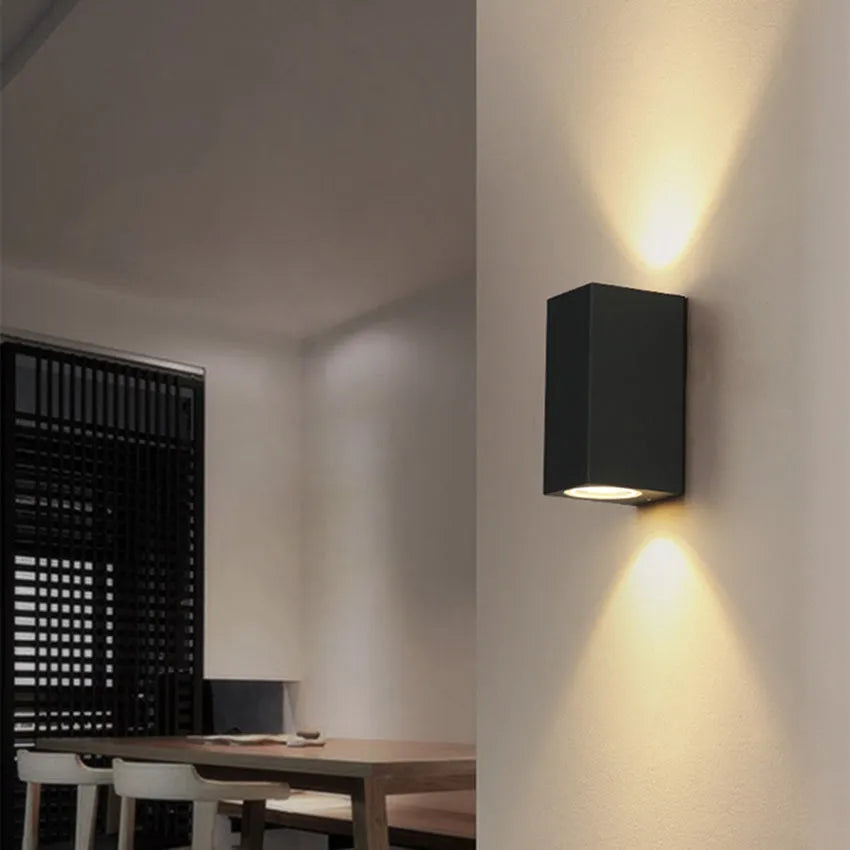 Modern black aluminium and glass wall lamp with silicone rubber detailing and integrated LED light.