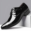 Glossy black men's formal shoes with pointed toe, low top, and carved detail on microfiber leather upper