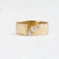 Gold-coloured women's fashion ring with shining zircon stones on a metal band