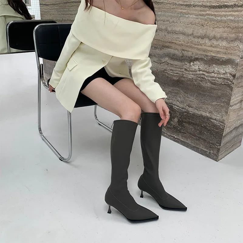 Black women's ankle boots with a pointed toe, stiletto heel, and a back zip fastening.