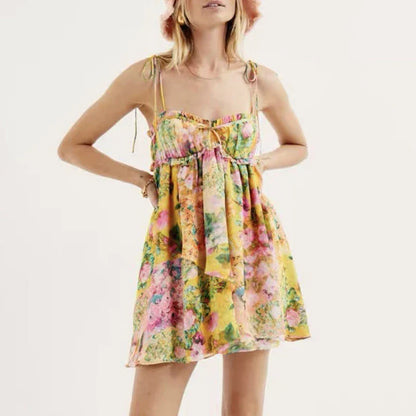 Stylish floral suspender dress with adjustable straps and playful ruffles, perfect for summer fun and fashion