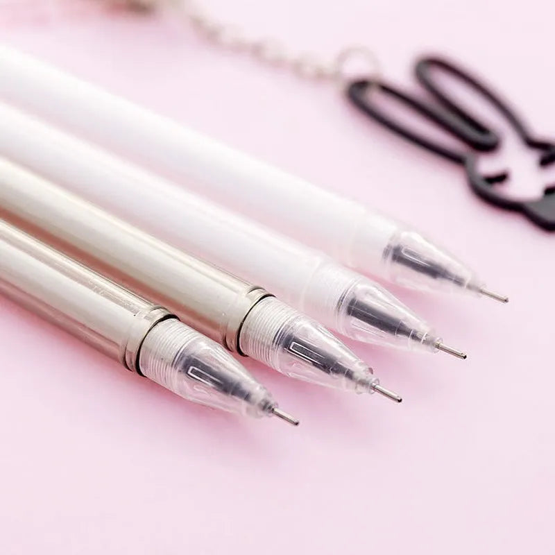 White and black gel pen with removable paper crane and rabbit pendant charms on a 17cm plastic body