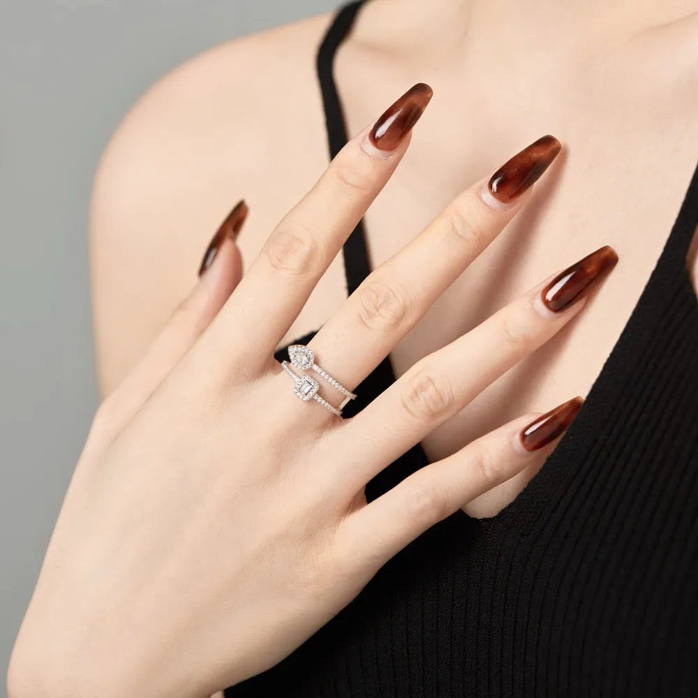S925 sterling silver water drop double-layer hollow ring platinum finish geometric design on white background