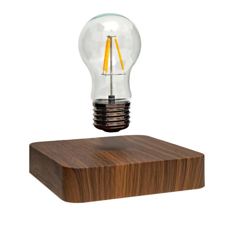 Self-rotating wireless powered maglev bulb with warm yellow light on a compact ABS base