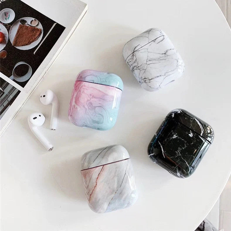White marble pattern AirPods protective case with hard PC construction showing charging port access