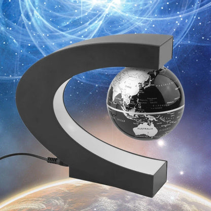 Magnetic levitation globe floating above base with LED light on