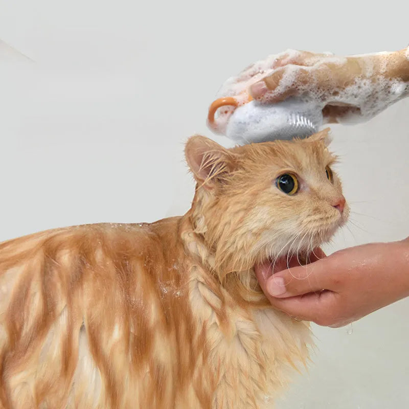 Orange dog bath brush with shampoo dispenser and soft TPR bristles for pet grooming