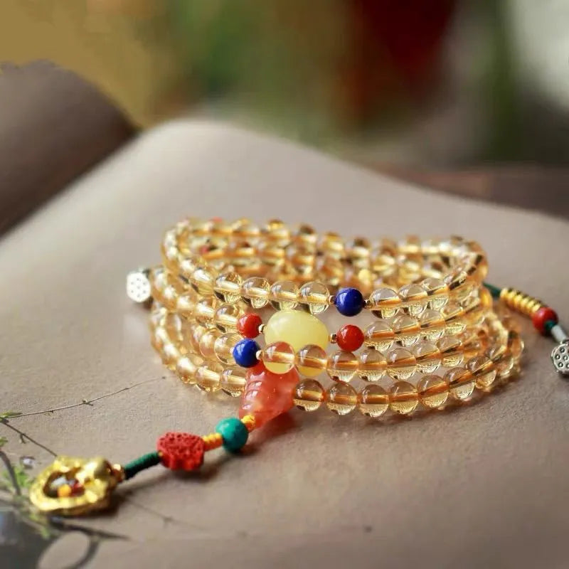 Yellow natural Brazilian citrine bracelet with 1mm beads and filament details on a wrist.