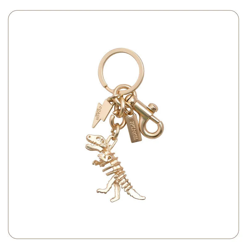 Golden bone dragon zinc alloy dinosaur keychain on a neutral background, showing retro animal pattern