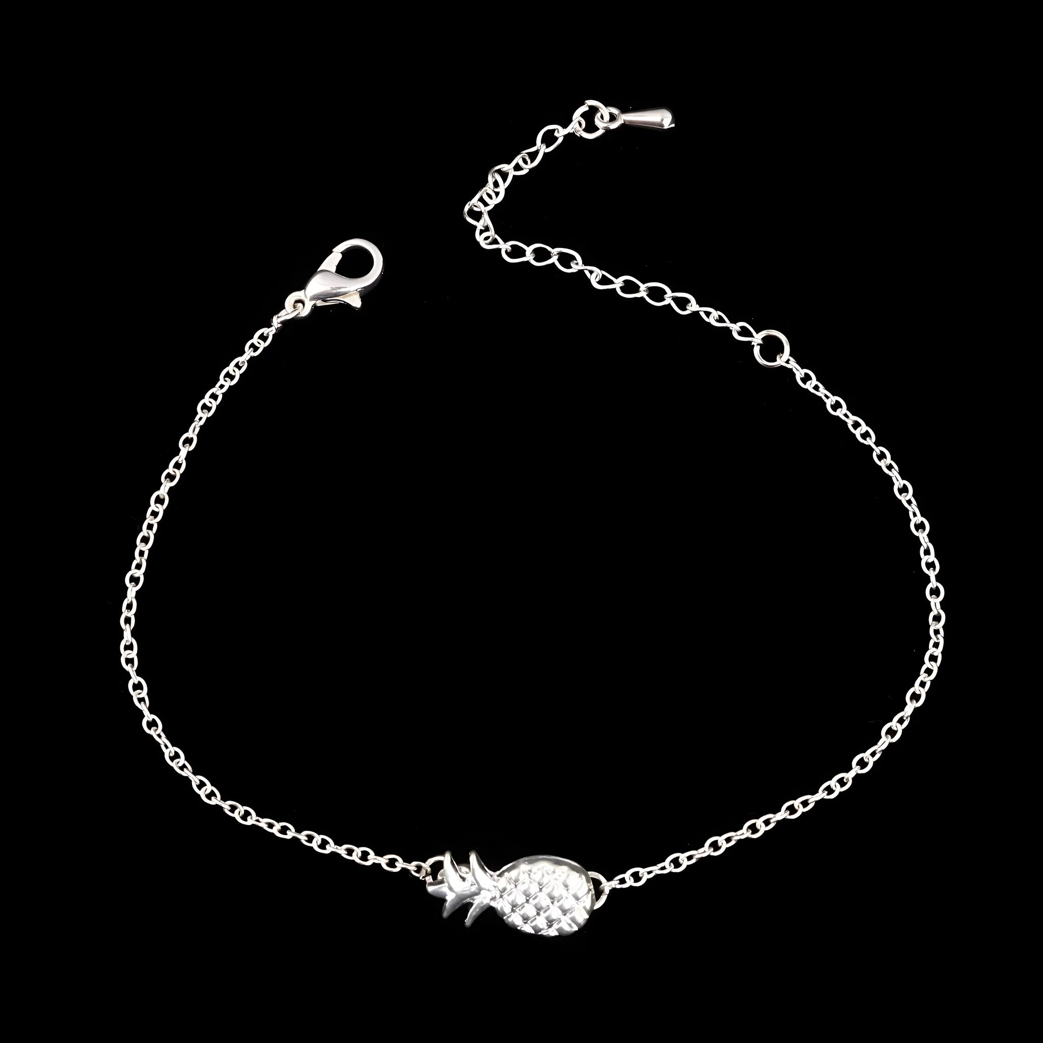 Women's alloy pineapple charm bracelet in gold or silver colour on a wrist.