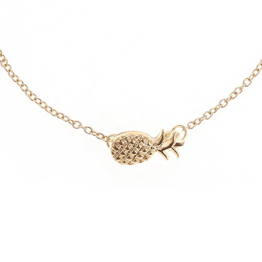 Women's alloy pineapple charm bracelet in gold or silver colour on a wrist.