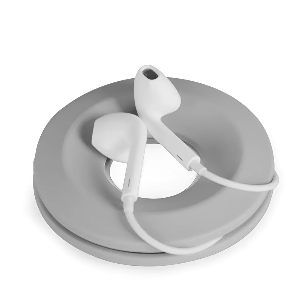 Donut-shaped silicone cord reel with suction cup base and magnet ring for organising cables