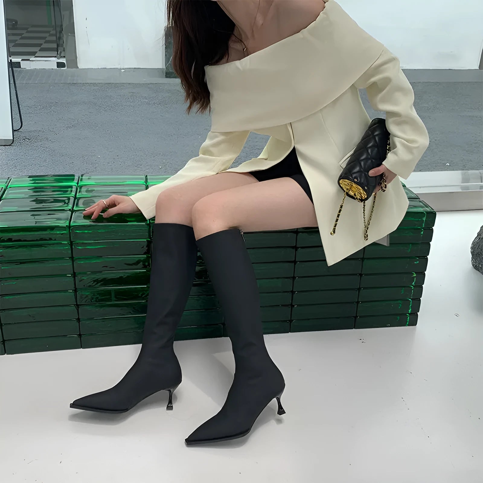 Black women's ankle boots with a pointed toe, stiletto heel, and a back zip fastening.