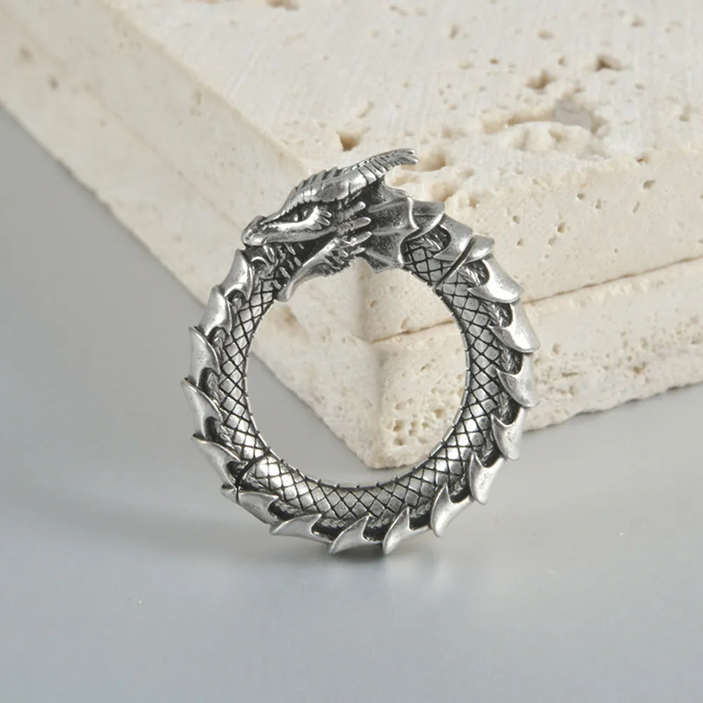 Large retro alloy earrings with hollow-out copper auricle shape and antique silver dragon design.