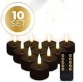 Four black S10 LED flameless tealight candles showing warm white glow.