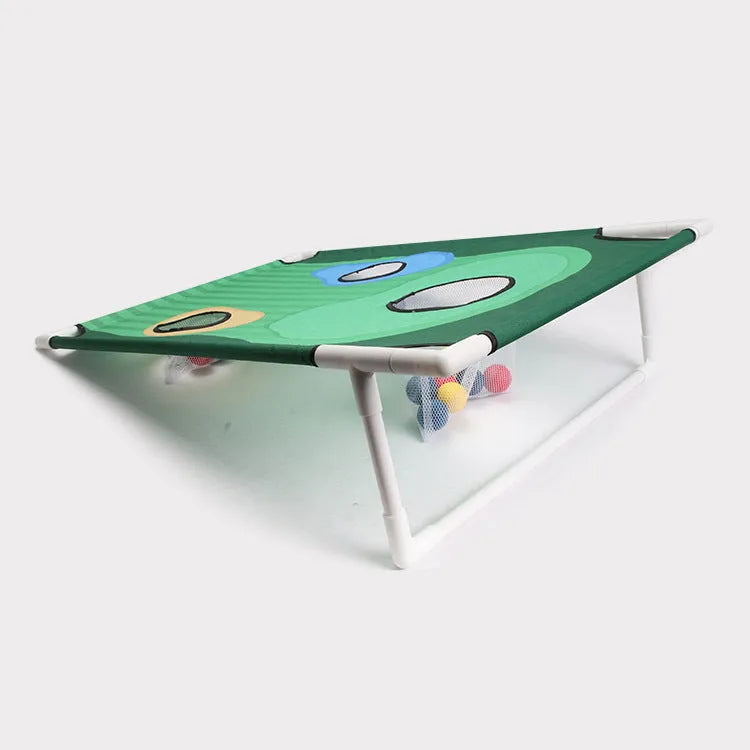 Green golf swing practice net with PVC frame and Oxford cloth target set up outdoors with balls and mat