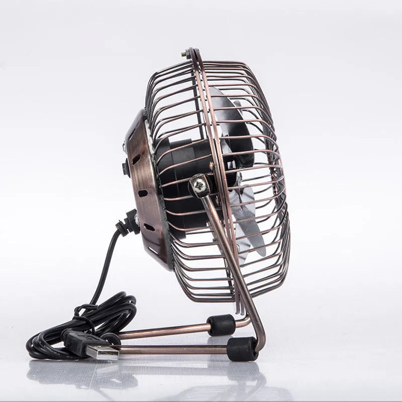 4-inch metal USB mini fan in bronze colour with rocker switch on desk