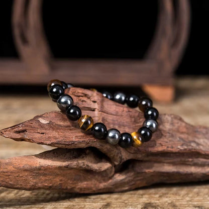 Hand-woven tiger eye stone bracelet in natural colours, showcasing unique texture and geometric design.
