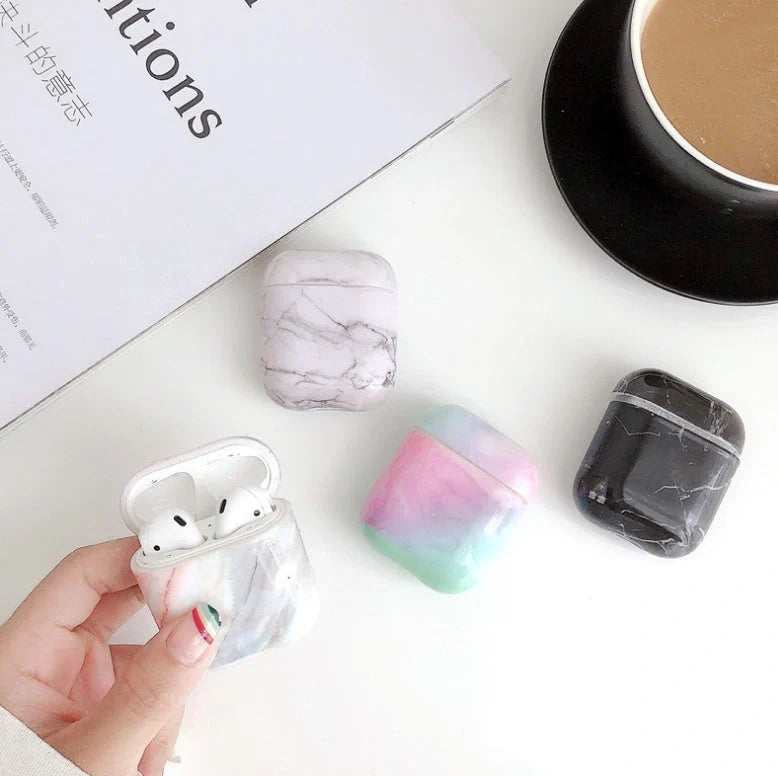 White marble pattern AirPods protective case with hard PC construction showing charging port access