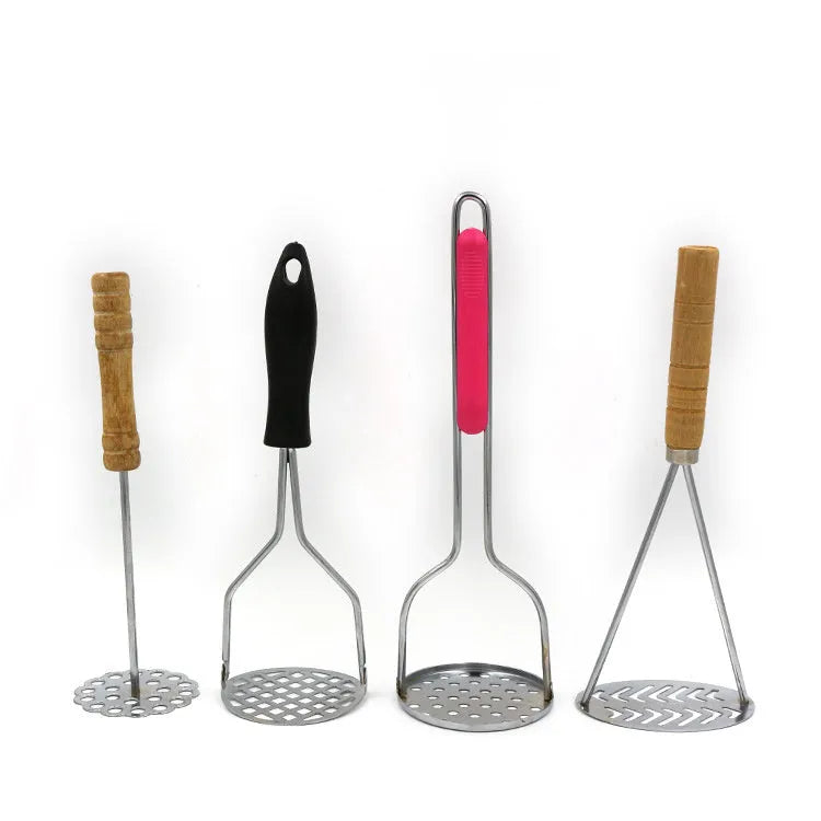 Manual potato masher with wooden handle and flower-shaped iron plated press head on a light surface