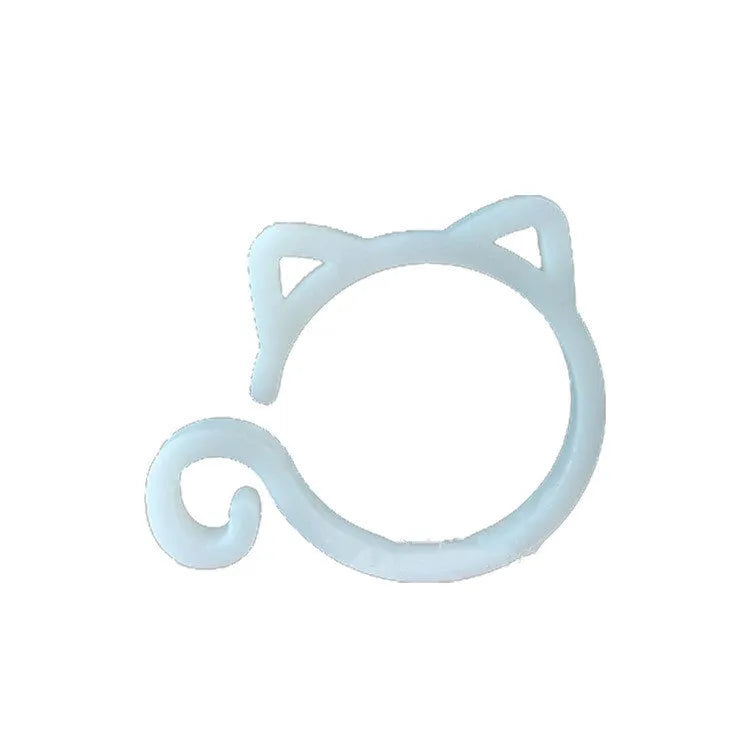 A green cat-shaped plastic plant clip for securing stems to garden supports.