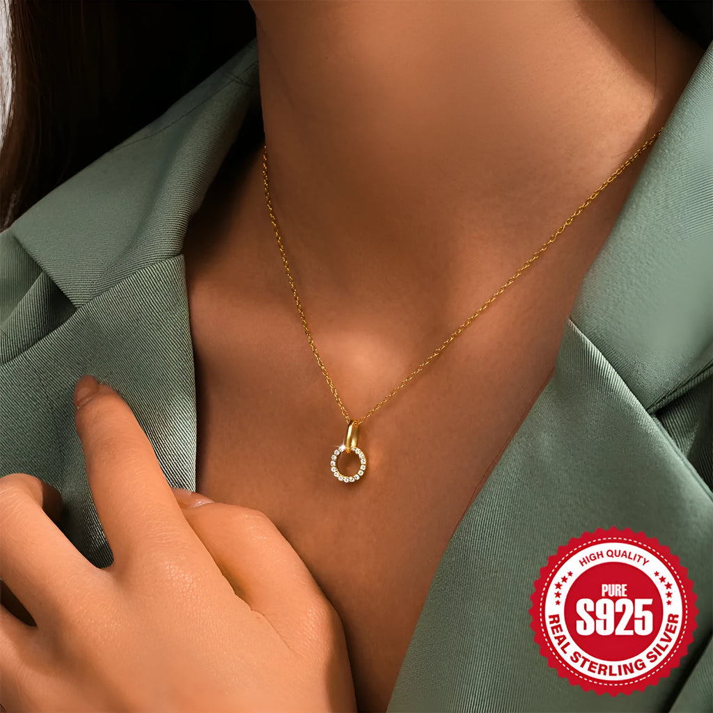 Gold geometric pendant necklace on a model, showing the interlocking design and adjustable clavicle chain.