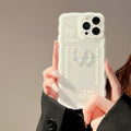 Clear iPhone case with a raised 3D bow design on the back, shown next to a white love lanyard.