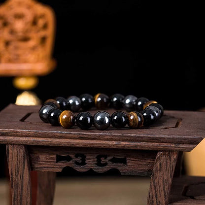 Hand-woven tiger eye stone bracelet in natural colours, showcasing unique texture and geometric design.