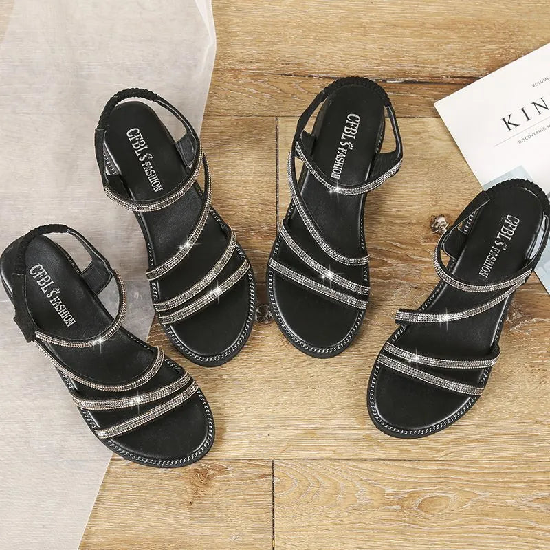 Korean style women's flat sandals in silver with rhinestone detail and elastic band.