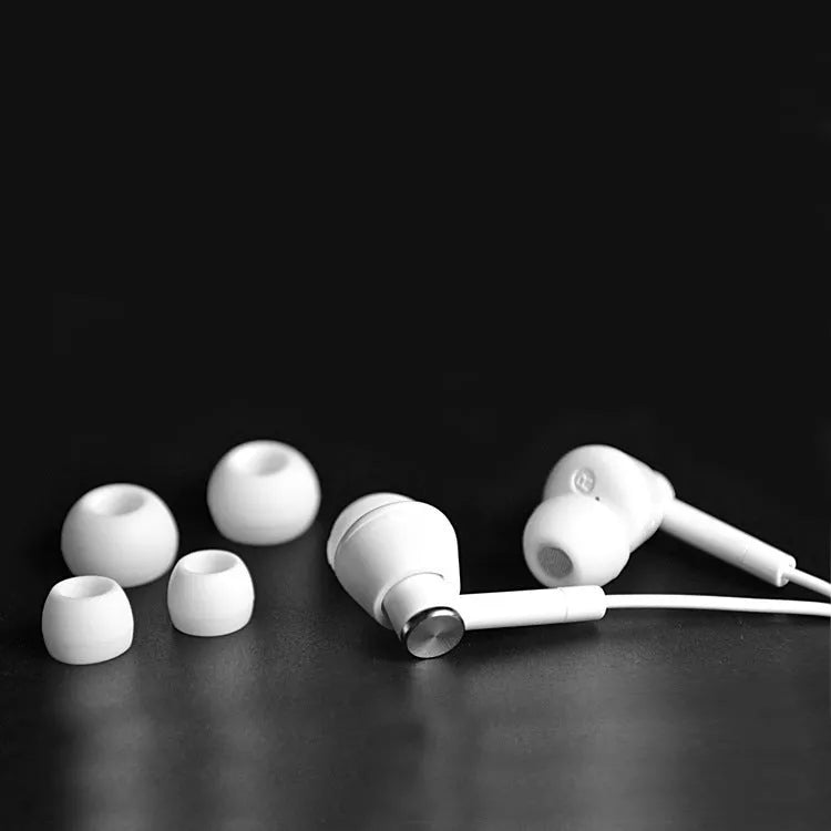 Black and white in-ear earphones with wired connection and subwoofer for computer and mobile phone use