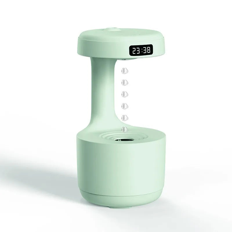 Rose gold and white columnar humidifier with levitating water drops and LED glow on a desk