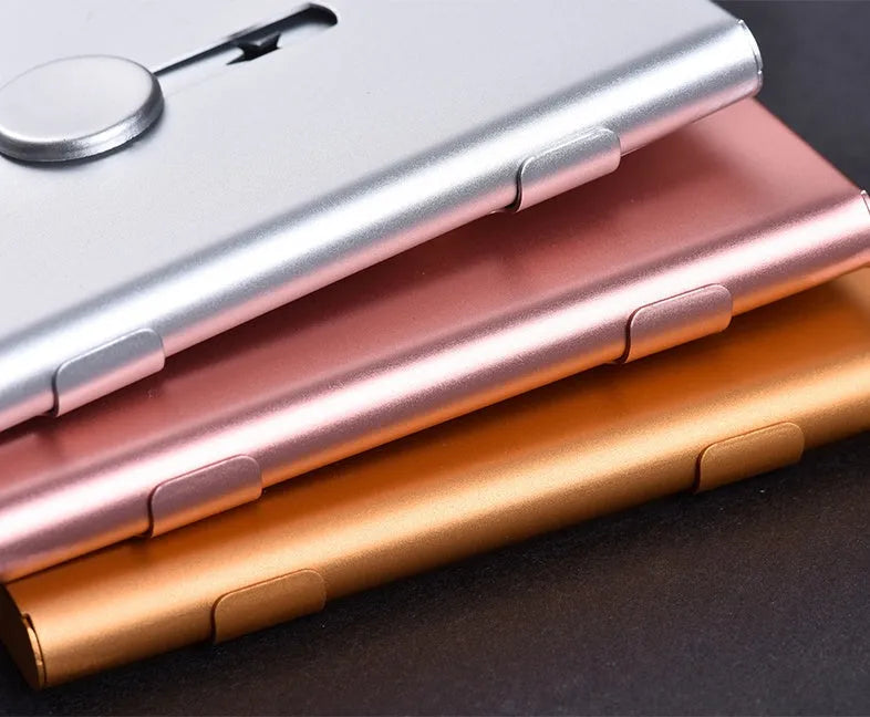 Hand push aluminium business card case in silver shown open with cards and internal layers visible