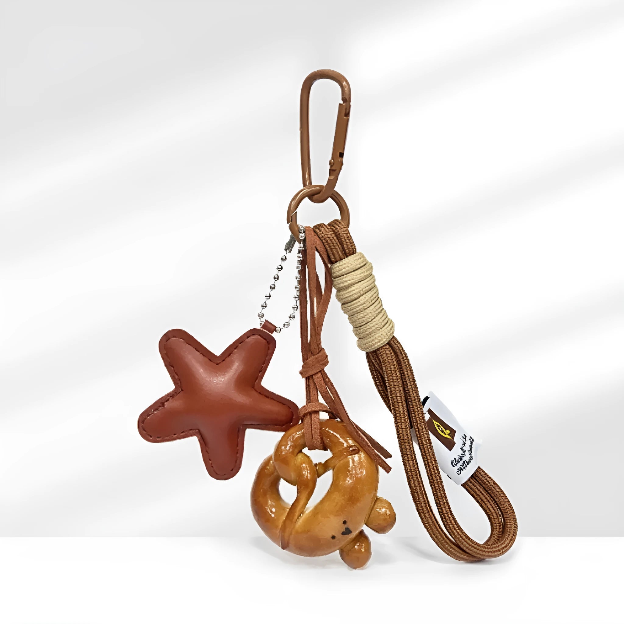 Handmade brown bread-themed handbag pendant charm with cartoon croissant, bagel, star, berry, and alkaline knot designs.