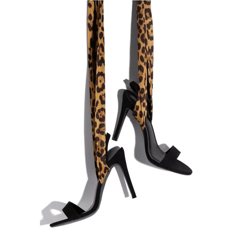 Light brown leopard print women's high-heeled sandals with cross straps and a stiletto heel.