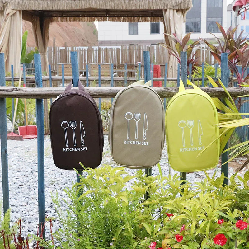 Brown portable storage bag containing a 12-piece stainless steel picnic kitchenware set.