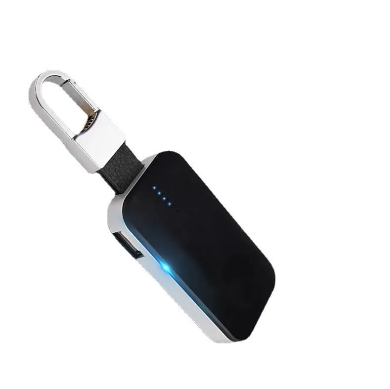 Black portable wireless power bank keychain for charging Apple Watch on a keyring.