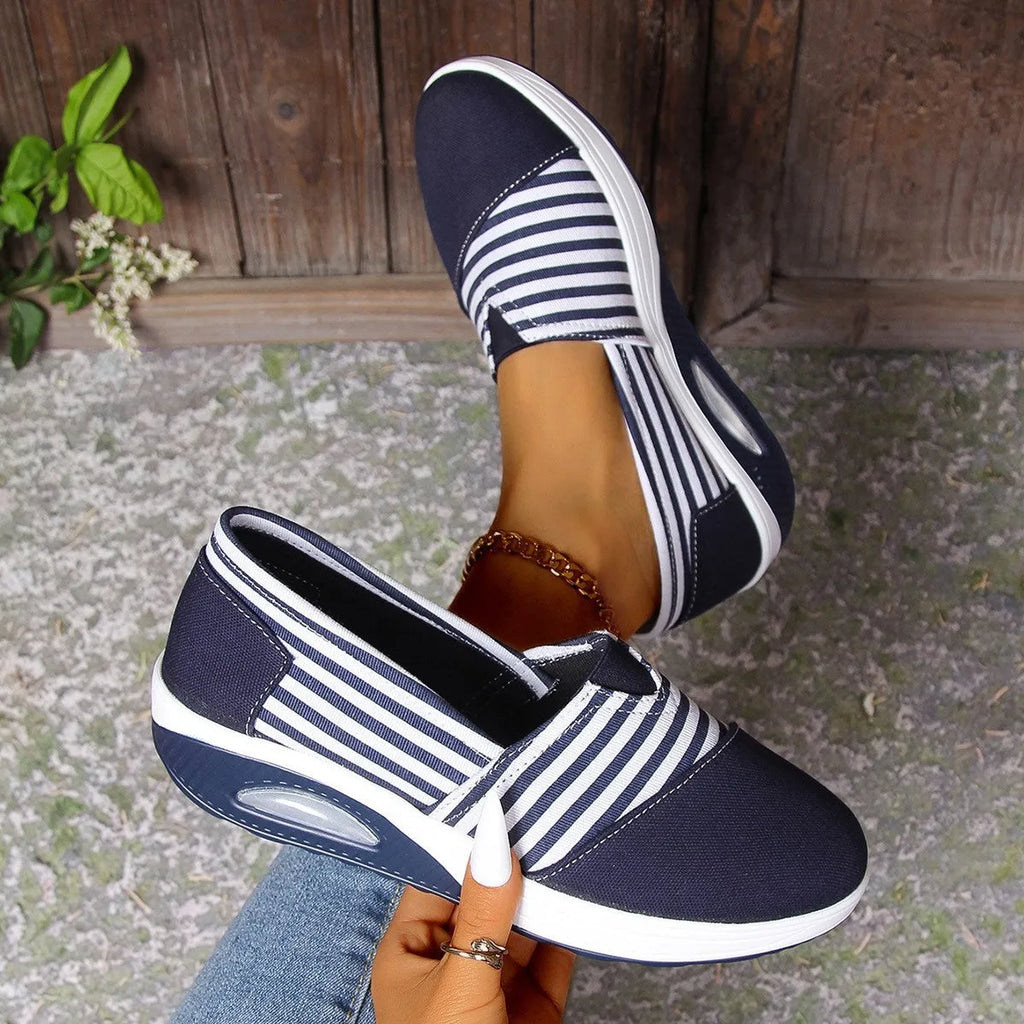 Striped canvas casual women's shoes with round head, low-top upper, and flat platform heel in blue and red.