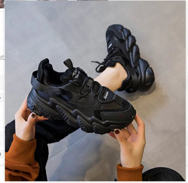 Women's black thick sole casual shoes with round toe and cow leather upper on white background