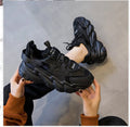Women's black thick sole casual shoes with round toe and cow leather upper on white background