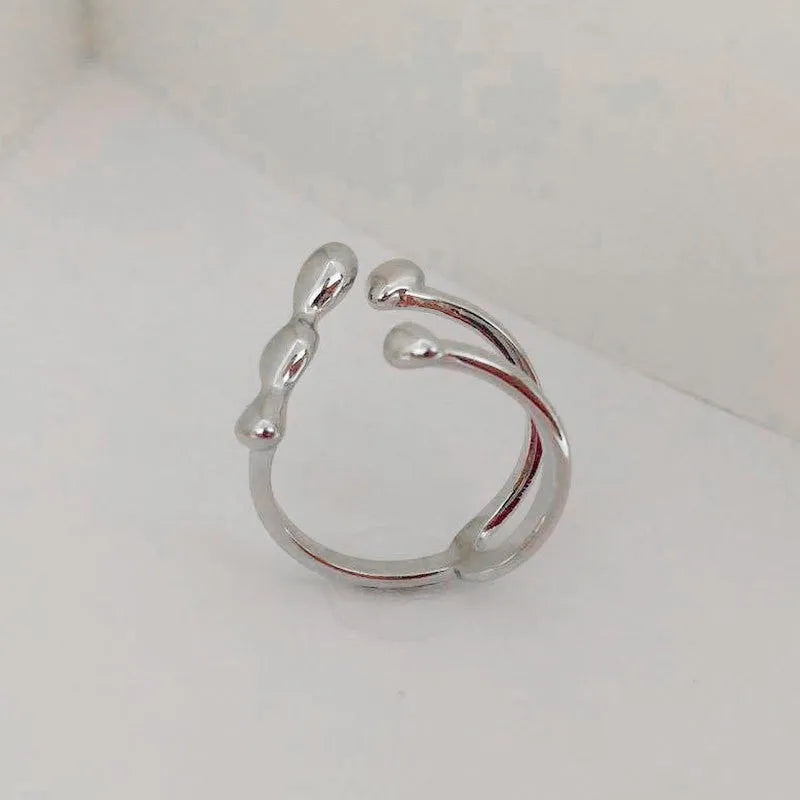 Gold and silver brass women's fashion ring with spherical design detail.