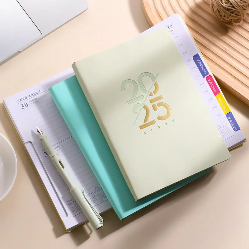 A5 2025 daily planner with soft faux leather cover in blue, green, pink, purple, or yellow.