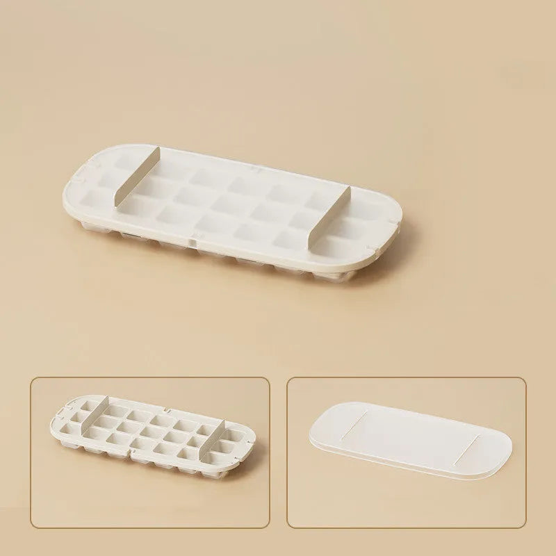 Colourful high-capacity ice cube tray with grid design and an ice shovel stored in its slot.