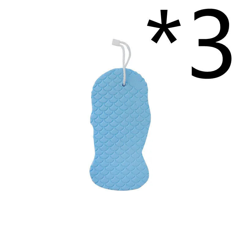 White 3D fish scale pattern bath sponge ball on a bathroom surface.