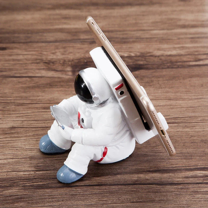 Astronaut-themed resin phone stand with unique design for desk decoration