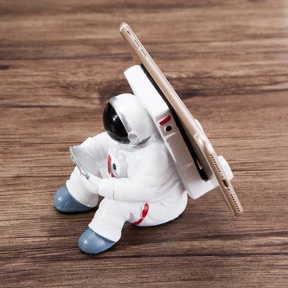 Astronaut-themed resin phone stand with unique design for desk decoration