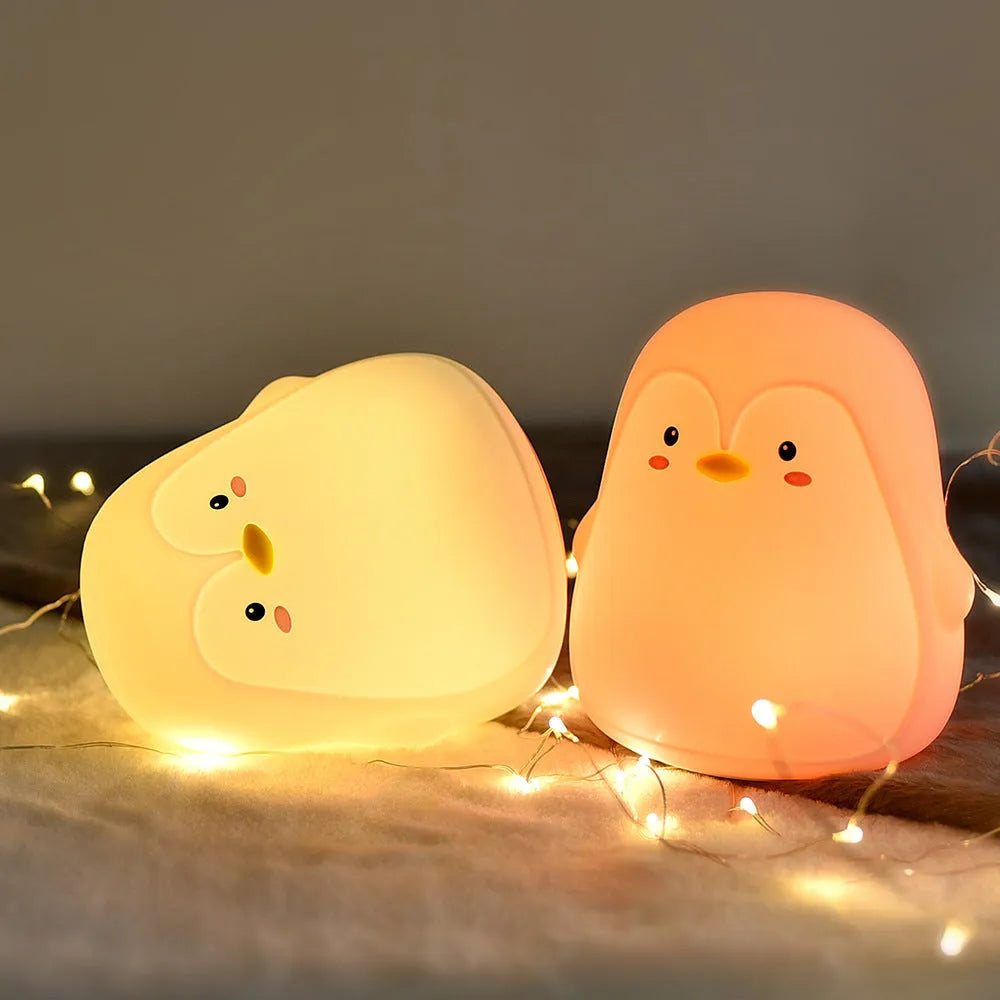 White silicone and ABS penguin-shaped rechargeable night light with USB cable