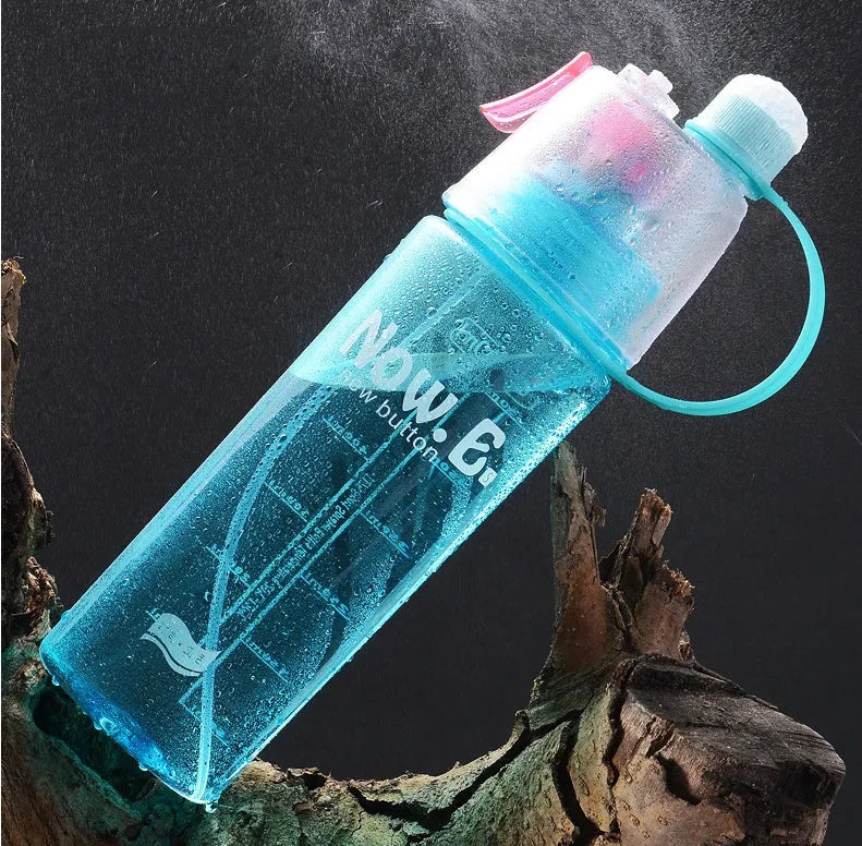 Green portable outdoor mist spray cup with handle, leakproof pad, and visible water level scale.